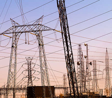 A number of power poles and high voltage lines grouped close to each other
